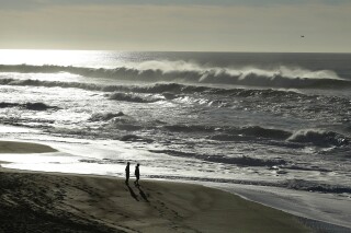 FILE - A couple walk along the North Beach at the Point Reyes National Seashore, Calif. on Tuesday, Jan. 1, 2013. Authorities searched a remote section of California's Point Reyes National Seashore on Monday, Oct. 2, 2023, for a swimmer missing since a possible shark attack during the weekend. (AP Photo/Ben Margot, File)