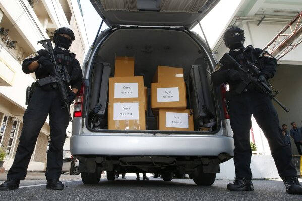 
              Thai policemen stand guard next to 100 kilograms of seized marijuana before a news conference Bangkok, Thailand, Tuesday, Sept. 25, 2018. Thai police handed over around 100 kilograms of seized marijuana to be used for medical research Tuesday, as officials seek to produce pot-based medication. (AP Photo/Sakchai Lalit)
            