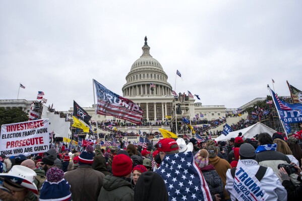 FILE - Insurrections loyal to President Donald Trump rally at the U.S. Capitol in Washington on Jan. 6, 2021. A Chicago man who stole a prized photograph from then-House Speaker Nancy Pelosi's office during the U.S. Capitol riot was sentenced on Friday, July 14, 2023, to more than four years in prison for his role in the mob's attack on the building. Kevin James Lyons, 40, took a wallet from a Pelosi staffer’s coat and a framed photograph of Pelosi with the late Congressman John Lewis, a civil rights movement icon who died in July 2020. (AP Photo/Jose Luis Magana, File)