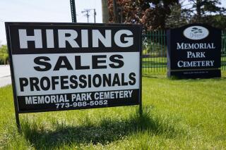 A hiring sign is displayed at a cemetery in Skokie, Ill., Wednesday, May 10, 2023. On Thursday, the Labor Department reports on the number of people who applied for unemployment benefits last week. (AP Photo/Nam Y. Huh)