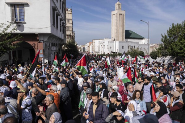 FILE - Thousands of Moroccans take part in a protest in solidarity with Palestinians in Gaza and against normalisation with Israel, in Casablanca, Morocco, Sunday, Oct. 29, 2023. Countries in the Middle East that have normalized or are considering normalizing relations with Israel are coming under growing public pressure to cut those ties because of Israel's war with Hamas. The protesters' demands present an uncomfortable dilemma for governments that have enjoyed the benefits of closer military and economic ties with Israel in recent years. (AP Photo/Mosa'ab Elshamy, File)