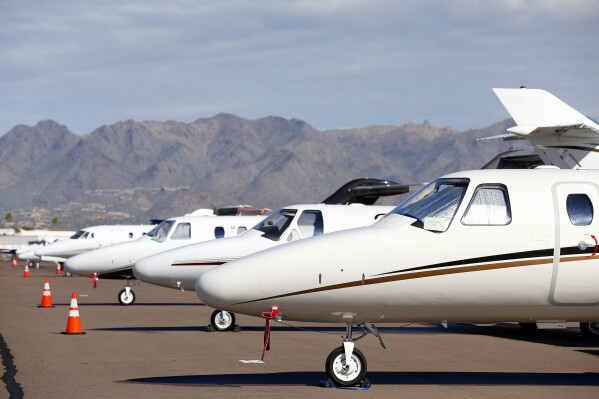 FILE - Private jets sit parked at Scottsdale Airport Jan. 27, 2015, in Scottsdale, Ariz. IRS leadership said Wednesday, Feb. 21, 2024, that the agency will start up dozens of audits on businesses' private jets and how they are used personally by executives and written off as a tax deduction 鈥� as part of the agency's ongoing mission of going after high-wealth tax cheats who game the tax system at the expense of American taxpayers. (APPhoto/Ross D. Franklin, File)