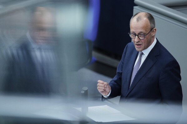 German opposition leader and Christian Democratic Union party chairman Friedrich Merz speaks during a debate and voting about loosen the country's debt rules and change constitution in the German Parliament Bundestag in Berlin, Germany, Tuesday, March 18, 2025. (AP Photo/Ebrahim Noroozi)