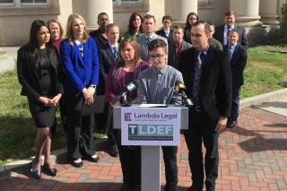 FILE - Connor Thonen-Fleck addresses reporters while his parents stand by his side on March 11, 2019, in Durham, N.C., at the announcement of a lawsuit against North Carolina officials over how the state health plan is run. State Treasurer Dale Folwell and the plan's executive administrator appealed a federal court ruling last summer that declared the plan's refusal of coverage for “medically necessary services," including hormone replacement therapy and surgeries, unconstitutional. The 4th U.S. Circuit Court of Appeals heard oral arguments Wednesday, Jan. 25, 2023. (AP Photo/ Jonathan Drew, File)