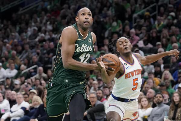Boston Celtics center Al Horford (42) drives toward the basket as New York Knicks guard Immanuel Quickley (5) defends in the first half of an NBA basketball game, Sunday, March 5, 2023, in Boston. (AP Photo/Steven Senne)