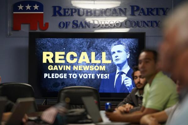 People listen during a meeting of volunteers to get out the vote by supporters of the effort to recall California Gov. Gavin Newsom at the San Diego Republican Party Headquarters, Monday, Sept. 13, 2021, in San Diego. Republicans led by former President Donald Trump are already claiming California's gubernatorial recall election is rigged. That messaging poses a problem for Republican Party officials, who are encouraging everyone to vote while maintaining concerns about the state's election security. (AP Photo/Gregory Bull)
