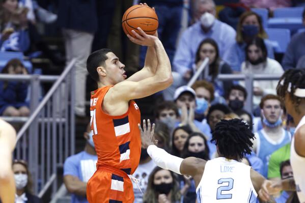 Syracuse's Cole Swider (21) hits a 3-pointer as North Carolina's Caleb Love (2) defends during the first half of an NCAA college basketball game in Chapel Hill, N.C., Monday, Feb. 28, 2022. (Ethan Hyman/The News & Observer via AP)