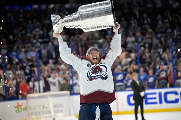 Colorado Avalanche left wing Gabriel Landeskog (92) lifts the Stanley Cup after the team defeated the Tampa Bay Lightning in Game 6 of the NHL hockey Stanley Cup Finals on Sunday, June 26, 2022, in Tampa, Fla. (AP Photo/Phelan M. Ebenhack, file)