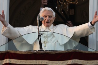 FILE- In this Thursday, Feb. 28, 2013 file photo, Pope Benedict XVI greets the crowd from the window of the Pope's summer residence of Castel Gandolfo, the scenic town where he will spend his first post-Vatican days and make his last public blessing as pope. (AP Photo/Andrew Medichini, File)