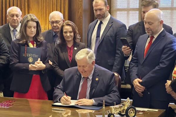 Missouri's Republican Gov. Mike Parson signs a bill to block Medicaid payments for Planned Parenthood, Tuesday, May 9, 2024, in his Jefferson City, Mo., Capitol office. (AP Photo/Summer Ballentine)
