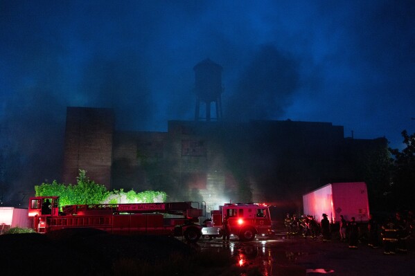 Baltimore firefighters battle a fire at a warehouse in West Baltimore Monday, May 12, 2025. (Jessica Gallagher/The Baltimore Banner via AP)