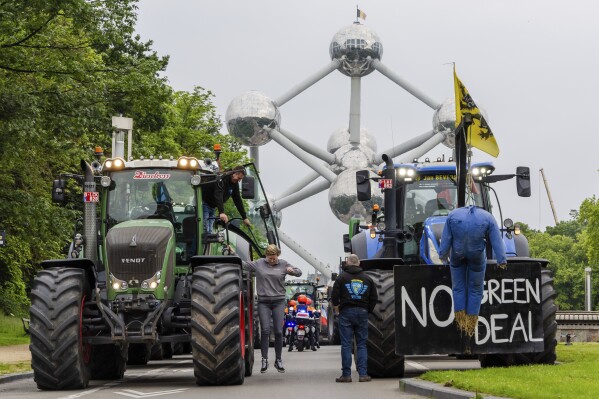 Farmers with their tractors gather around the Atomium in Brussels, Tuesday, June 4, 2024. Farmers are protesting in Brussels to put pressure on the European Union, just days before European Parliament elections. (AP Photo/Geert Vanden Wijngaert)