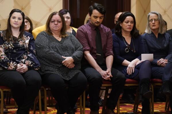 Families of the victims of the Newtown shooting and attorneys listen during a news conference in Trumbull, Conn., Tuesday, Feb. 15, 2022. The families of nine victims of the Sandy Hook Elementary School shooting have agreed to a $73 million settlement of a lawsuit against the maker of the rifle used to kill 20 first graders and six educators in 2012, their attorney said Tuesday. (APPhoto/Seth Wenig)