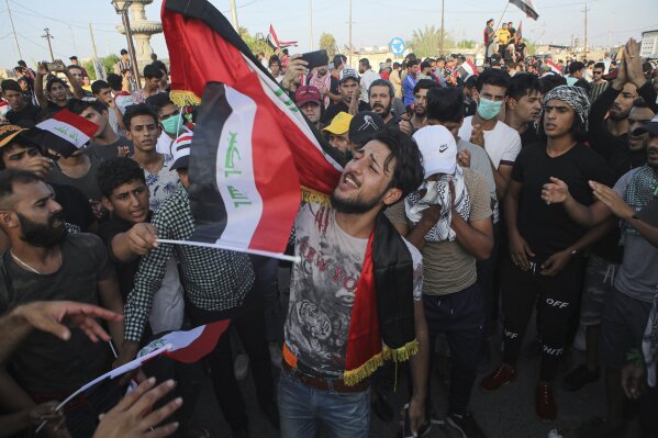 Anti-government protesters gather near Basra provincial council building during a demonstration in Basra, Iraq, Tuesday, Oct. 29, 2019. (AP Photo/Nabil al-Jurani)