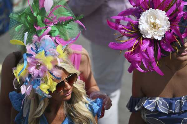 Race fans walk through the stands at Churchill Downs before the 151st running of the Kentucky Oaks horse race Friday, May 2, 2025, in Louisville, Ky. (AP Photo/Jon Cherry)