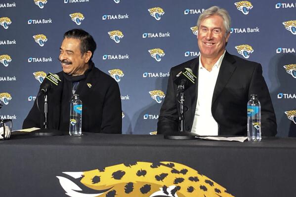 Jacksonville Jaguars owner Shahid Khan, left, and Doug Pederson, new head coach of the NFL football team, smile during a news conference, Saturday, Feb. 5, 2022, in Jacksonville, Fla. (AP Photo/Mark Long)