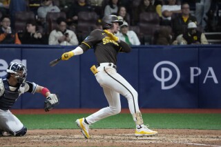 San Diego Padres' Jackson Merrill takes a single during the exhibition game between the Team Korea and San Diego Padres at the Gocheok Sky Dome in Seoul, South Korea, Sunday, March 17, 2024. The Los Angeles Dodgers and the San Diego Padres will meet in a two-game series on March 20th-21st in Seoul for the MLB World Tour Seoul Series. (AP Photo/Ahn Young-Joon)