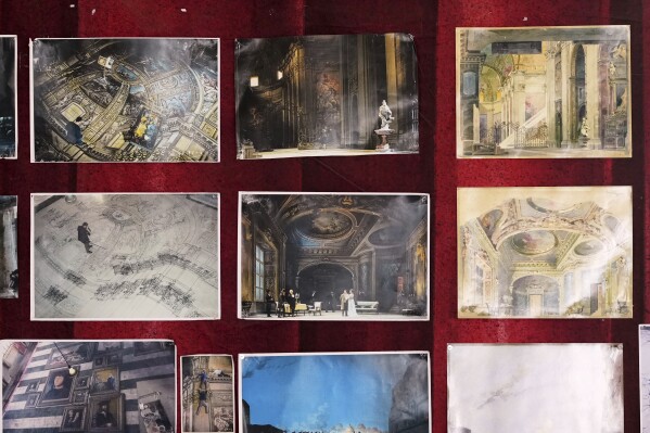 Photos of projects and stage canvases used for previous performances of Giacomo Puccini's "Tosca" opera are hang on a wall of the "Teatro dell' Opera" opera house warehouse, in Rome, Thursday, April 10, 2025. (AP Photo/Andrew Medichini)