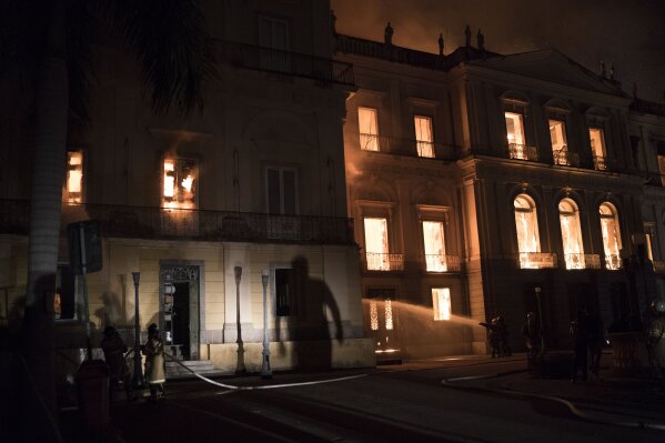 
              Firefighters battle the flames at the 200-year-old National Museum of Brazil, in Rio de Janeiro, Brazil, Sunday, Sept. 2, 2018. According to its website, the museum has thousands of items related to the history of Brazil and other countries. The museum is part of the Federal University of Rio de Janeiro. (AP Photo/Leo Correa)
            