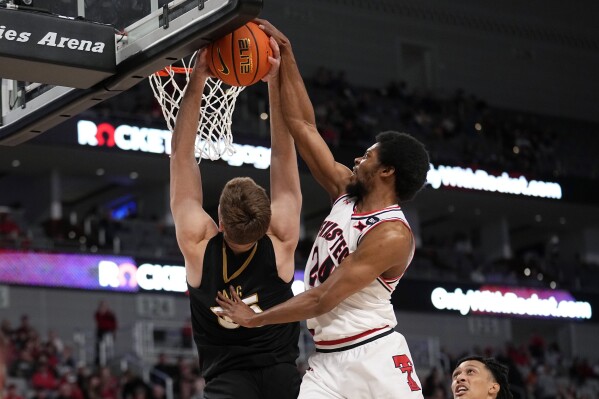 Vanderbilt forward Carter Lang, left, has his shot blocked by Texas Tech guard Kerwin Walton (24) in the second half of an NCAA college basketball game in Fort Worth, Texas, Saturday, Dec. 16, 2023. (AP Photo/Tony Gutierrez)