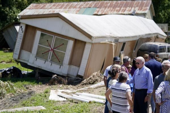 President Joe Biden tours a neighborhood impacted by flooding, Monday, Aug. 8, 2022, in Lost Creek, Ky. (AP Photo/Evan Vucci)