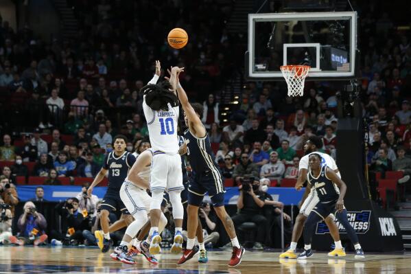 UCLA guard Tyger Campbell (10) shoots a three-pointer against Akron during the second half of a first-round NCAA college basketball tournament game, Thursday, March 17, 2022, in Portland, Ore. (AP Photo/Craig Mitchelldyer)
