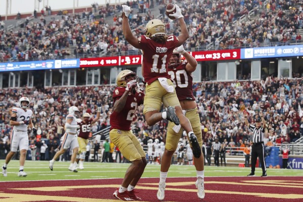 Boston College wide receiver Lewis Bond (11) celebrates his touchdown with wide receiver Joseph Griffin Jr. and tight end George Takacs during the second half of an NCAA college football game against Virginia, Saturday, Sept. 30, 2023, in Boston. (AP Photo/Michael Dwyer)