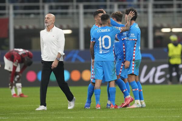 AC Milan's manager Stefano Pioli, left, walks past Atletico Madrid's players at the end of the Champions League group B soccer match between AC Milan and Atletico Madrid at the San Siro stadium in Milan, Italy, Tuesday, Sept. 28, 2021. (AP Photo/Antonio Calanni)