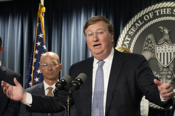 Mississippi Gov. Tate Reeves, right, announces a proposal that he says should alleviate financial problems for hospitals, during a news conference Thursday, Sept. 21, 2023, in Jackson, Miss. Associate Vice Chancellor for Clinical Affairs at the University of Mississippi Medical Center Dr. Alan Jones listens at left. (AP Photo/Rogelio V. Solis)