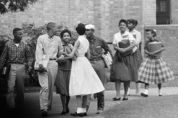 
              FILE - In this Oct. 2, 1957, file photo, the first black students to enroll at Central High School in Little Rock, Ark., leave the building and walk toward a waiting Army station wagon following their classes. Monday, Sept. 25, 2017, marks the 60th anniversary of when nine black students enrolled at the Arkansas school. One of the nine students is obscured by another student in this photograph. (AP Photo/Ferd Kaufman, File)
            