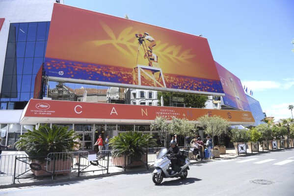 FILE - A scooter drives past the Palais des festivals appears during the 72nd international film festival, Cannes, southern France on May 13, 2019. The 77th annual Cannes Film Festival begins on May 14. (Photo by Arthur Mola/Invision/AP, File)