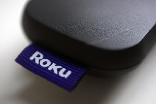 FILE - The Roku logo is affixed to a remote control in Portland, Ore., Aug. 13, 2020. Roku will carry Major League Baseball games on Sundays beginning this week, and viewers will be able to watch for free and not be required to use a Roku device, the streaming service announced Monday, May 13, 2024. (AP Photo/Jenny Kane, File)