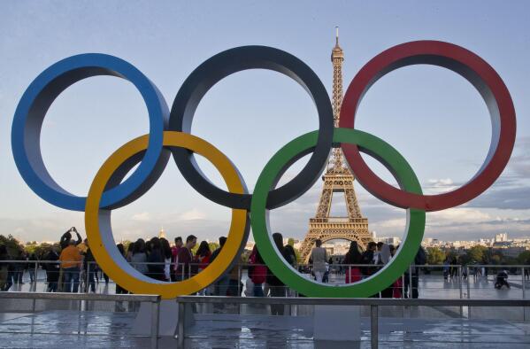 FILE - The Olympic rings are set up in Paris, France, Thursday, Sept. 14, 2017 at Trocadero plaza that overlooks the Eiffel Tower, a day after the official announcement that the 2024 Summer Olympic Games will be in the French capital. An IOC inspection team has given a resounding thumbs-up to Paris’ preparations for the 2024 Olympic Games. The IOC said Wednesday that Paris organizers are where they should be in their planning with 415 days to go before the opening ceremony. (AP Photo/Michel Euler, File)