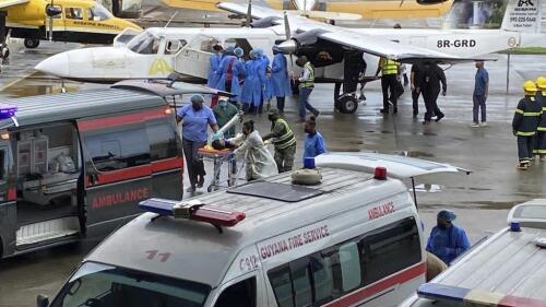 Injured children arrive to the airport in Georgetown, Guyana, Monday, May 22, 2023. A nighttime fire raced through a secondary school dormitory in the town of Mahdia early Monday, killing at least 19 students and injuring several others, authorities said. (AP Photo/Royston Drake)