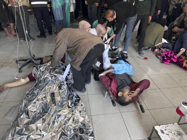 Palestinians wounded in an Israeli strike while waiting for humanitarian aid on the beach in Gaza City are treated in Shifa Hospital in Gaza City, Thursday, Feb. 29, 2024. (AP Photo/Mahmoud Essa)