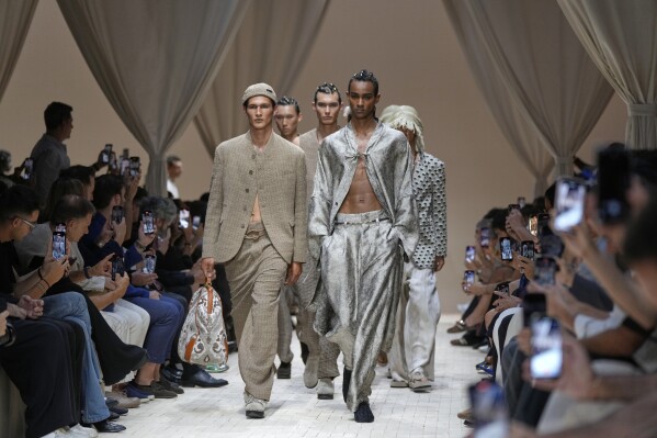 Models wear creations as part of the men's Emporio Armani Spring-Summer 2026 collection, that was presented in Milan, Italy, Saturday, June 21, 2025. (AP Photo/Luca Bruno)