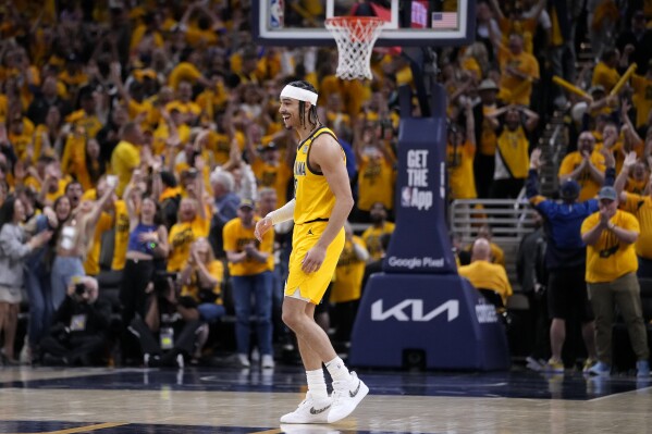 Indiana Pacers guard Andrew Nembhard celebrates after making a three-point basket during the second half of Game 3 against the New York Knicks in an NBA basketball second-round playoff series, Friday, May 10, 2024, in Indianapolis. The Pacers won 111-106. (AP Photo/Michael Conroy)