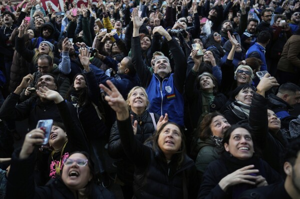 Supporters of Argentina's former President Cristina Fernandez gather outside her home two days after the nation's Supreme Court upheld Fernandez's corruption conviction in Buenos Aires, Argentina, Thursday, June 12, 2025. (AP Photo/Natacha Pisarenko)