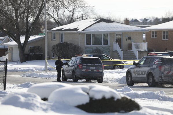Police work at the scene of a shooting in Tinley Park on Sunday, Jan. 21, 2024. Authorities have identified a woman and her three adult daughters who were found slain inside their suburban Chicago home in what police are calling a domestic-related shooting. (Eileen T. Meslar/Chicago Tribune via AP)