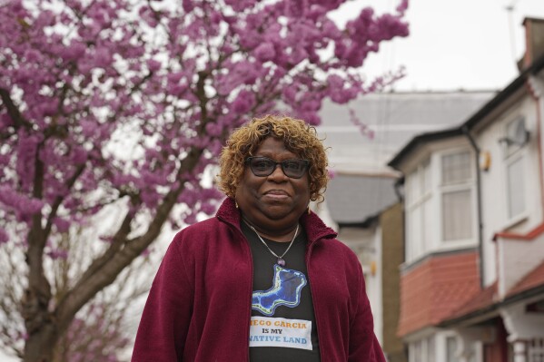 Chagossian Bernadette Dugasse poses for a photograph outside her home in London, Tuesday, March 25, 2025. (AP Photo/Kin Cheung)