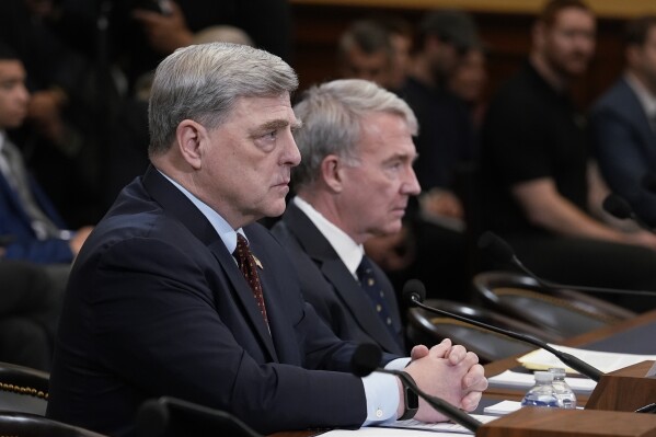 Retired Gen. Mark Milley, left, the former chairman of the Joint Chiefs of Staff, left, and retired Gen. Kenneth McKenzie, former commander of the U.S. Central Command, speak to the House Foreign Affairs Committee about the U.S. withdrawal from Afghanistan, at the Capitol in Washington, Tuesday, March 19, 2024. (AP Photo/J. Scott Applewhite)