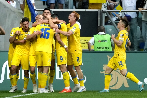 Ukraine's players celebrate the opening goal during the Euro 2024 group C qualifying soccer match between Ukraine and England in Wroclaw, Poland, Saturday, Sept. 9, 2023. (AP Photo/Czarek Sokolowski)