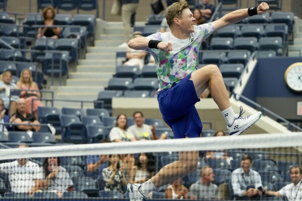 Harri Heliovaara, of Finland, leaps over the net after winning the mixed doubles final with Anna Danilina, of Kazakhstan, against Jessica Pegula, of the United States, and Austin Krajicek, of the United States, at the U.S. Open tennis championships, Saturday, Sept. 9, 2023, in New York. (AP Photo/Mary Altaffer) during the mixed doubles final of the U.S. Open tennis championships, Saturday, Sept. 9, 2023, in New York. (AP Photo/Mary Altaffer)