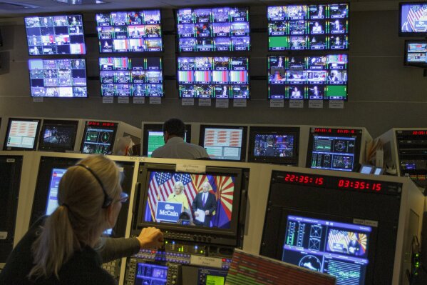In this Nov. 8, 2016, photo, staff members of The Associated Press Television Network work in master control at the Washington bureau of The Associated Press in Washington, as returns come in during election night. The Associated Press says it plans to peel back the curtain and let people know how its experts declare winners and losers on election night. Given high interest in the presidential race, the complicating factor of strong early voting and President Donald Trump's warnings about potential fraud, television executives are making similar promises of transparency. (AP Photo/Jon Elswick)