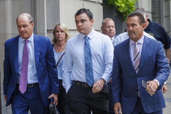 Philadelphia police officer Mark Dial, center, arrives at the Juanita Kidd Stout Center for Criminal Justice in Philadelphia, Tuesday, Sept. 19, 2023, with attorneys for a bail hearing. Brian McMonigle is at left and at right is Fortunato Perri. Dial, a Philadelphia police officer charged in the shooting death of a driver last month is back in custody following the revocation of his bail after prosecutors challenged the constitutionality of his release.(Alejandro A. Alvarez/The Philadelphia Inquirer via AP)
