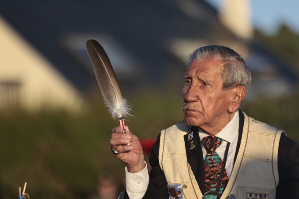 FILE — WWII veteran Charles Shay, pays tribute to soldiers during a D-Day commemoration ceremony of the 78th anniversary for those who helped end World War II, in Saint-Laurent-sur-Mer, Normandy, France, Monday, June 6, 2022. On D-Day, Charles Shay was a 19-year-old Native American army medic who was ready to give his life — and actually saved many. Now 99, he's spreading a message of peace with tireless dedication as he's about to take part in the 80th celebrations of the landings in Normandy that led to the liberation of France and Europe from Nazi Germany occupation. (AP Photo/ Jeremias Gonzalez, File)