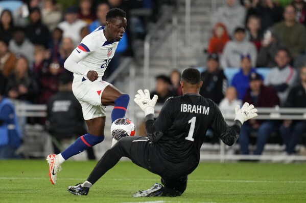 Oman goalkeeper Ibrahim Almukhaini (1) stops a shot by United States' Folarin Balogun during the first half of an international friendly soccer match Tuesday, Sept. 12, 2023, in St. Paul, Minn. (AP Photo/Abbie Parr)