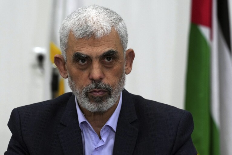 FILE - Yehya Sinwar, head of Hamas in Gaza, chairs a meeting with leaders of Palestinian factions at his office in Gaza City, Wednesday, April 13, 2022. Israel can either try to annihilate Hamas, which would mean almost certain death for the estimated 100 hostages still held in Gaza, or it can cut a deal that would allow the militants to claim a historic victory. Either outcome would be excruciating for Israelis. And either might be seen as acceptable by Hamas, which valorizes martyrdom. (AP Photo/Adel Hana, File)