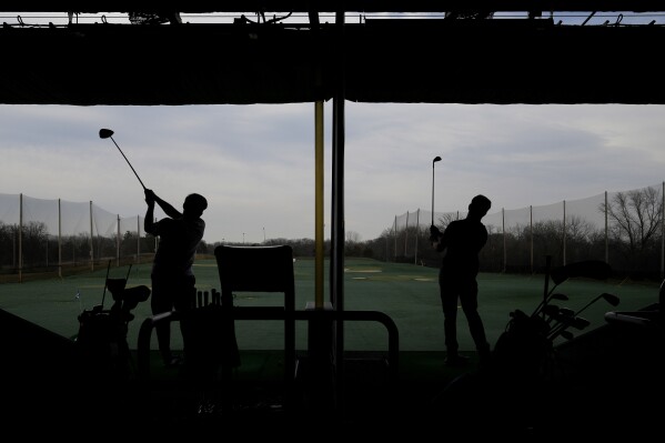Golfers hit range balls during a warm day in Des Plaines, Ill., Tuesday, Feb. 27, 2024. Illinois broke a 24 year old temp record with today's estimated 68 degree high and a 98 year old record set back in 1926 appears potentially in jeopardy Tuesday. These readings are May level temps, the equivalent of normal temps which occur here more than 2 months from now. (AP Photo/Nam Y. Huh)