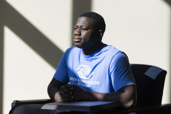 Steeve Biondolillo sits for a portrait on campus at Northwest Nazarene University in Nampa, Idaho on Friday, Oct. 7, 2022. With an early childhood in Haiti marked by poverty and other trauma, 19-year-old Biondolillo seems to have beat long odds. (AP Photo/Kyle Green)